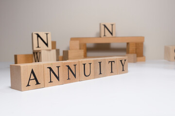 Annuity. The term economy and trade. Written in wooden cubes.