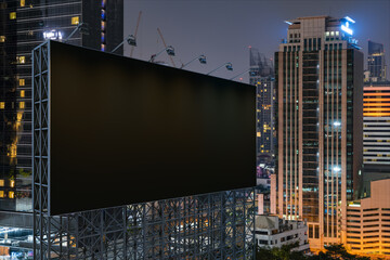 Blank black road billboard with Bangkok cityscape background at night time. Street advertising poster, mock up, 3D rendering. Side view. The concept of marketing communication to promote idea.