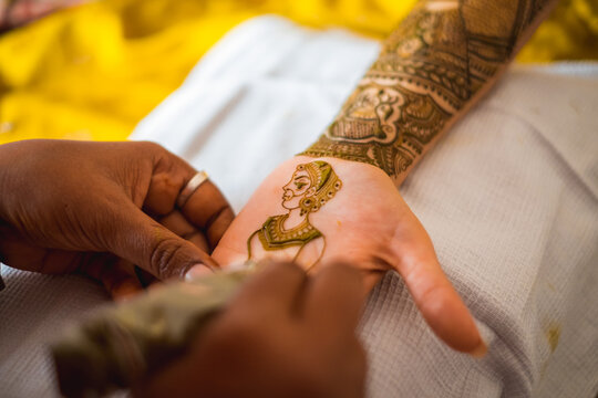 hand of an indian bride decorated with henna or mehndi