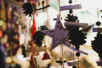 Details of a Christmas market at night, a star, and other ornaments and decorations against the light. Bokeh, and blur background. Cologne, Germany