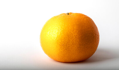 Tangerine on a white background with shadows close-up