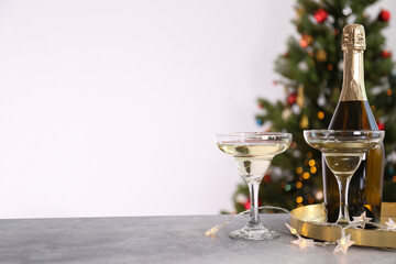 Beautiful christmas composition with two glasses of sparkling wine, decorations on textured table. New year's eve tradition to celebrate with champagne. Close up, copy space, background.