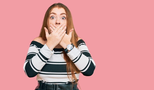 Young beautiful redhead woman wearing elegant clothes shocked covering mouth with hands for mistake. secret concept.