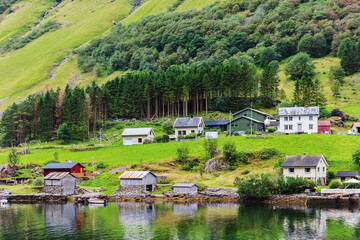 Fototapeta na wymiar Reflection of village in norwegian fiord