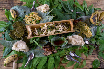 Traditional bamboo soup with salads, chicken and rice as side dishes. This is part of the gastronomy from the tribes in northern Laos