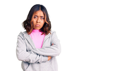 Young beautiful mixed race woman wearing casual sporty clothes skeptic and nervous, disapproving...
