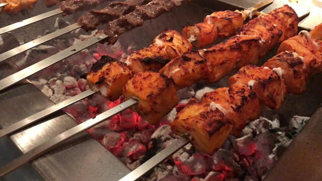 kofta kebabs on charcoal barbecue with smoke.