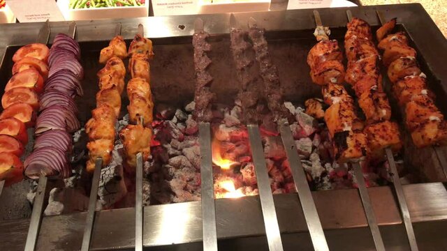 kofta kebabs on charcoal barbecue with smoke.
