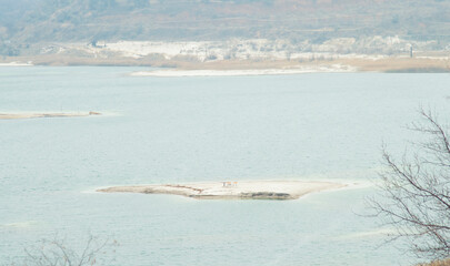a pond with islets of sand in the water