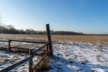 wooden fence in an open field