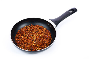 Cayenne pepper in black bowl on white background