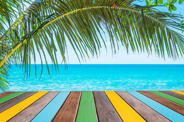 Multicolor wood table top and sea beach background.