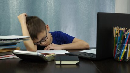 the boy falls asleep sitting at the table. study at home. - Powered by Adobe