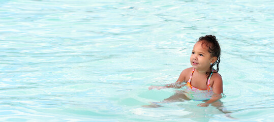 Young toddler girl in a pool