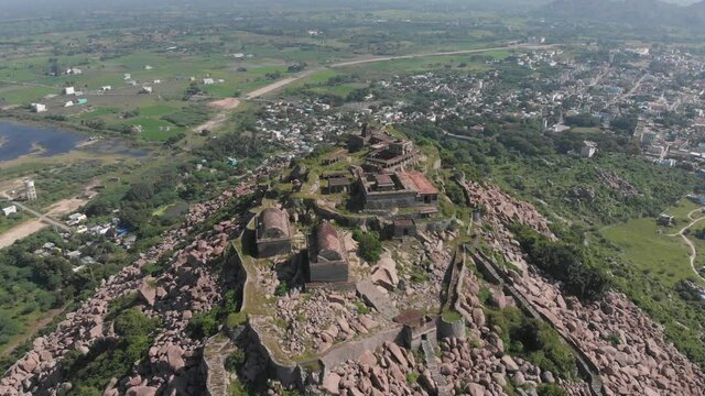 Slow aerial forward shot showing Krishnagiri Fort complex build on top of mountain.