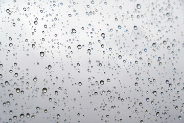 water droplets on glass and view of the landscape, droplets on close-up glass,