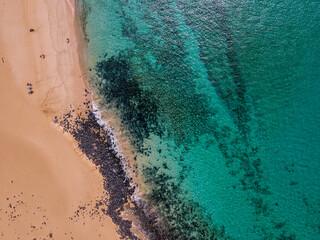 Aerial view of the jagged shores and beaches of La Graciosa island. Bathers on the beach of las Conchas. The main archipelago island Chinijo, a mile northwest of Lanzarote. Canary island. Spain. Ocean