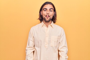 Young handsome man wearing business clothes making fish face with lips, crazy and comical gesture. funny expression.