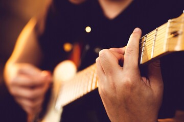 rocker plays solo part on string instrument.