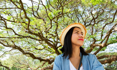 Asain woman Relaxation with a tree background.