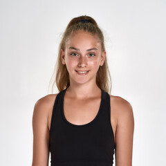 Portrait of cute sportive girl child in sportswear smiling at camera while posing isolated over white background