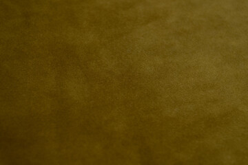 Golden mustard colored velvet background. Soft fabric backdrop.