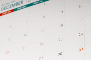 close up top view calendar 2020 month december end of the year schedule to make appointment meeting or manage timetable each day lay on yellow background for planning work and travel concept.