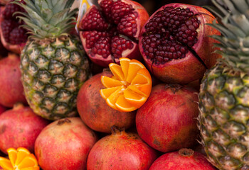 Oranges,pomegranate and pineapple in the street market in Istanbul.Fresh fruits for fresh juice

