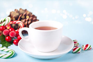 Hot winter tea with christmas decoration and candy cane
