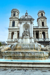 Obraz premium The church of Saint Sulpice in Paris with a beautiful fountain