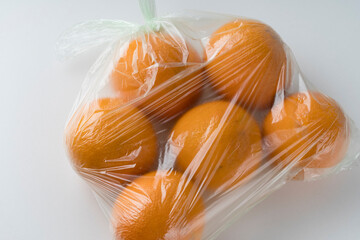 fresh oranges in a transparent plastic bag