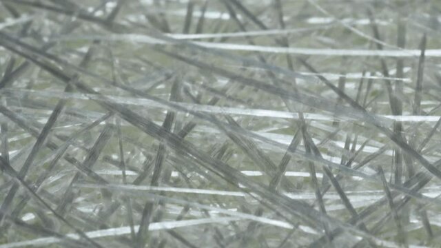 Camera flight from above, over sheets of white fiberglass, close-up video.