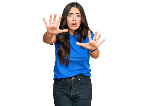Beautiful brunette young woman wearing casual clothes doing stop gesture with hands palms, angry and frustration expression