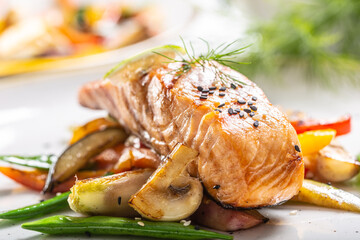 Healthy cooked Norwegian salmon served with grilled vegetables and mushrooms