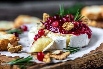 Baked or fried grilled Camembert or brie cheese with berry sauce or jam. Gourmet traditional Breakfast close up