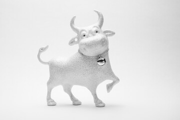 Christmas toy of a cheerful white bull on a white background