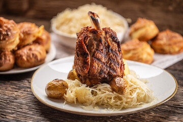 Bavarian pork knuckle with sauerkraut and baked potatoes