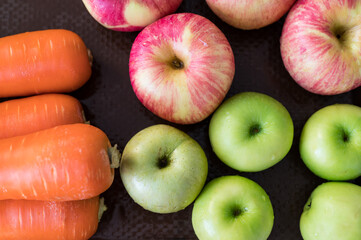 Red and green apples with carrots on plate .Healthy food concept.Different color.