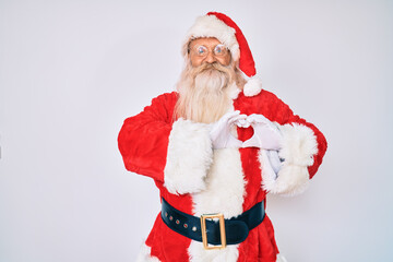 Old senior man with grey hair and long beard wearing santa claus costume smiling in love showing heart symbol and shape with hands. romantic concept.