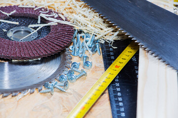 Carpenter tools on wooden table with sawdust. Circular Saw. Carpenter workplace top view.