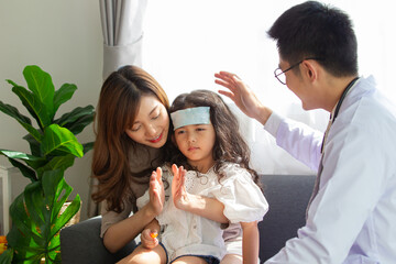 Asian Mother takes her sick young daughter to see a doctor in hospital.
