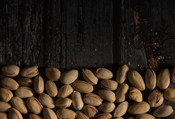 Pistachio on a dark wooden background