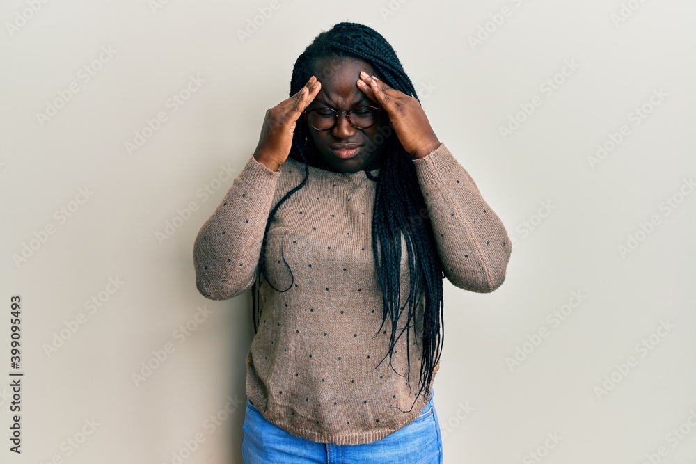 Poster young black woman with braids wearing casual clothes and glasses with hand on head for pain in head 