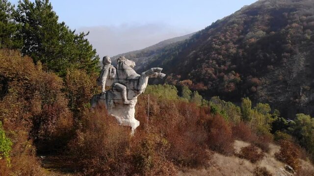White Stone Monument Of A Warrior Rider On Horseback In Targovishte, Bulgaria. - Aerial Tilt-Down Shot