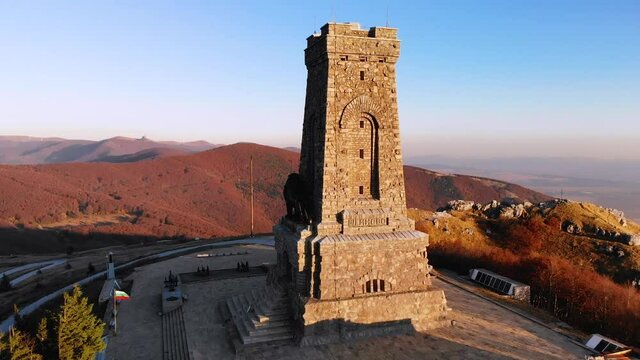 Historic Tower Of Shipka Monument During Golden Hour Of Sunset On Shipka Peak In Bulgaria. - aerial close up