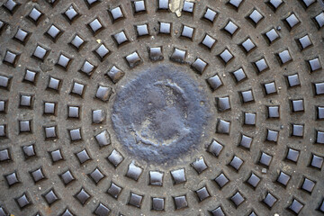 Rusty manhole cap, grunge manhole cover, round. Gray Background.