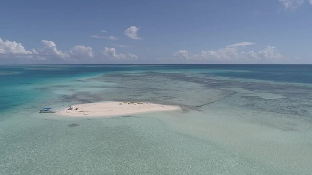 Los Roques Venezuela  drone aerial view  pan rigth Tropical Island sardine high tide left turn in descent