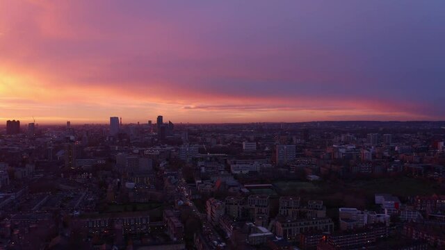 Dolly forward Aerial drone shot of residential buildings London at sunset
