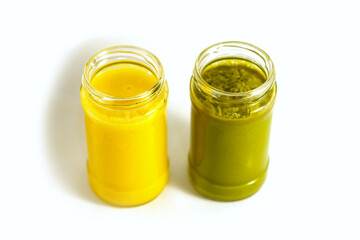 Two cans of freshly squeezed avocado and orange smoothie