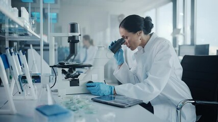 Medical Development Laboratory: Portrait of Beautiful Caucasian Female Scientist Looking Under Microscope, Analyzes Petri Dish Sample. Medicine, Biotechnology Research in Advanced Pharma Lab - Powered by Adobe